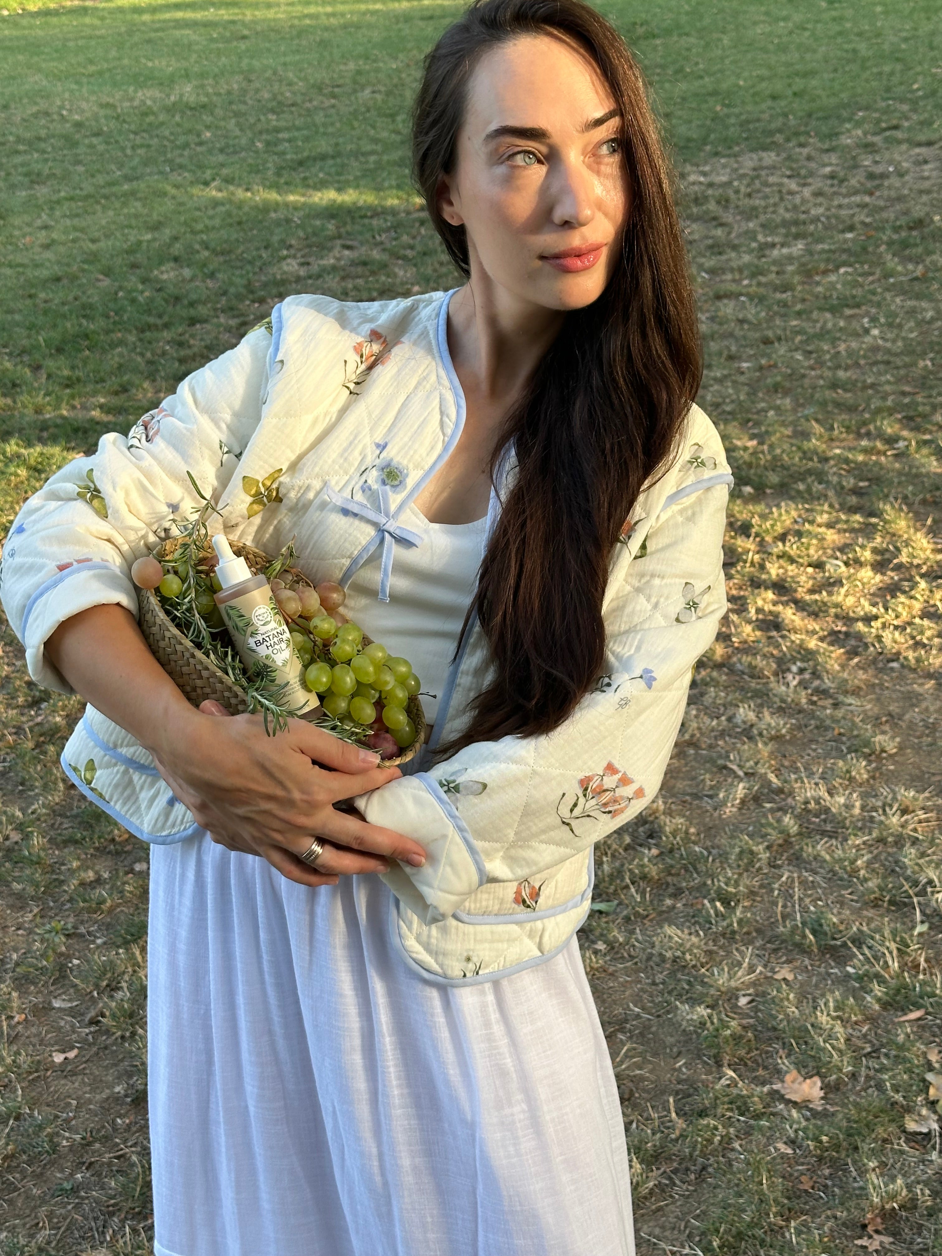 Woman using Prima Qualitas Batana Oil for dry and damaged hair
